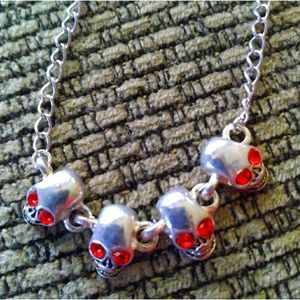 Skull bracelet silver tone red gem eyes 4 skulls new item goth wicca item